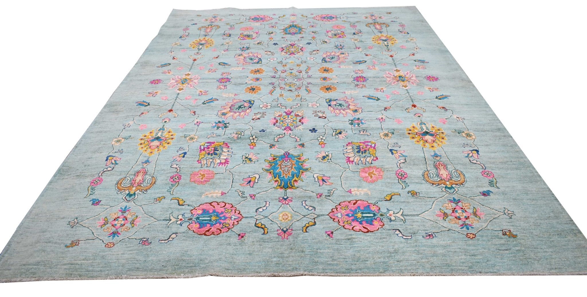 A handwoven Afghan Chobi rug featuring a light blue field with colorful floral and vine patterns.