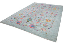 An Afghan Chobi rug featuring a light blue field with colorful floral and geometric motifs.