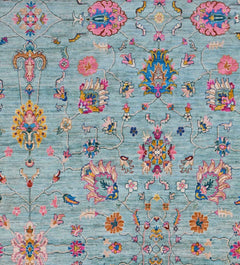 An Afghan Chobi rug featuring a traditional floral pattern in shades of blue, pink, and gold.