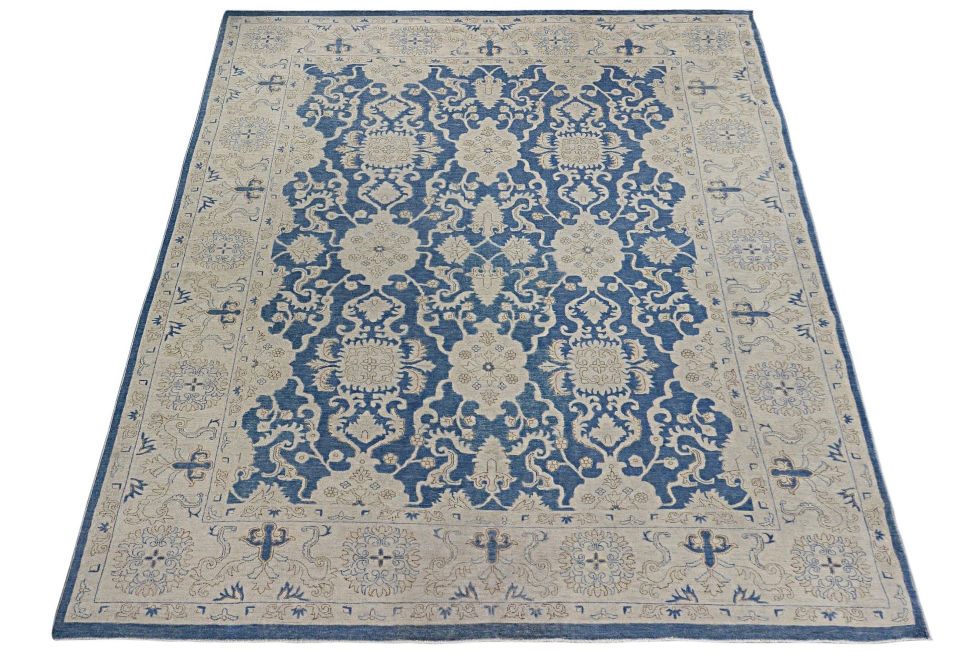 A rectangular Afghan Chobi rug featuring a traditional blue and beige floral pattern.