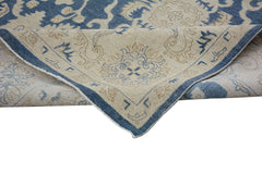 A handmade Afghan Chobi rug featuring a traditional blue and beige floral pattern.