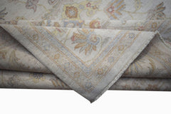 A folded Afghan Chobi rug featuring a traditional floral pattern in soft, earthy tones.