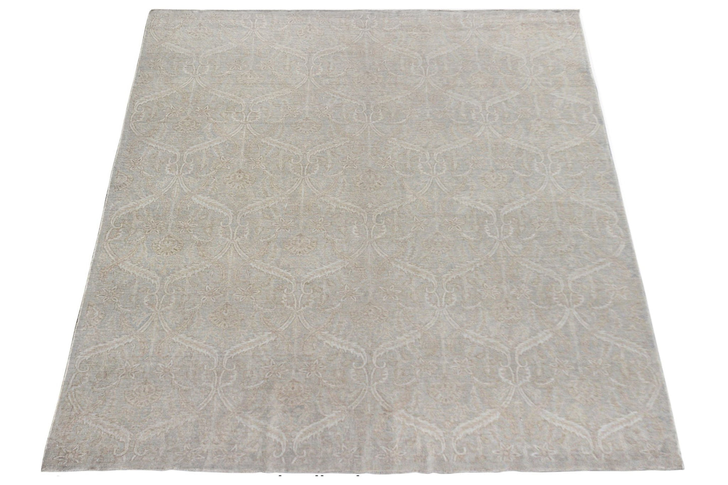 A handmade Afghan Chobi rug featuring a traditional floral pattern in soft neutral tones.