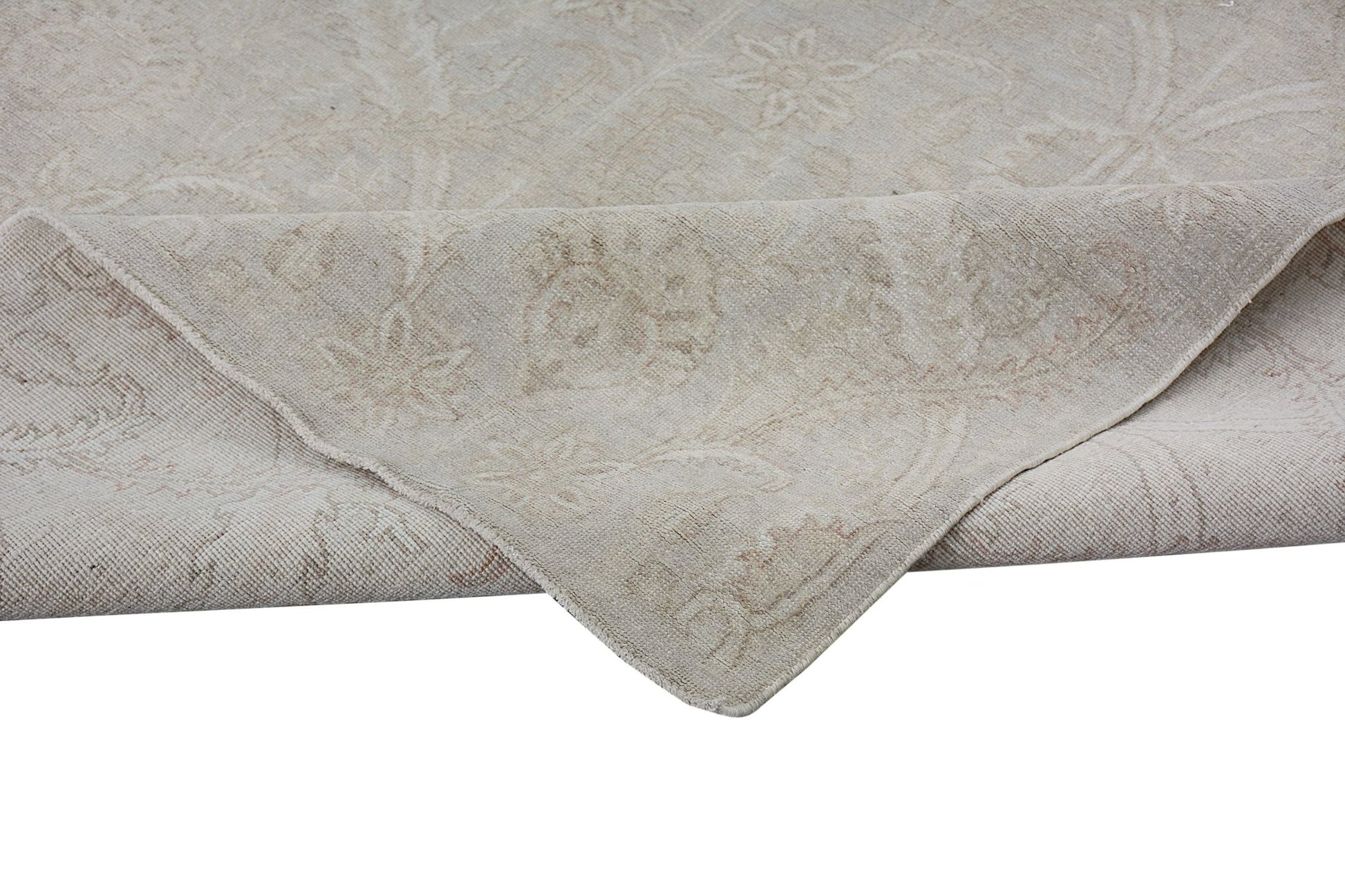 A handmade Afghan Chobi rug in neutral beige tones with a traditional floral pattern.