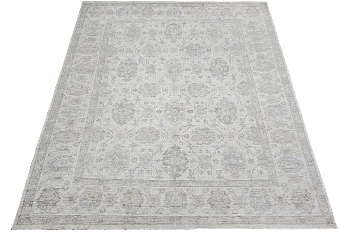 An Afghan Chobi rug featuring a traditional floral pattern in soft beige and grey tones.