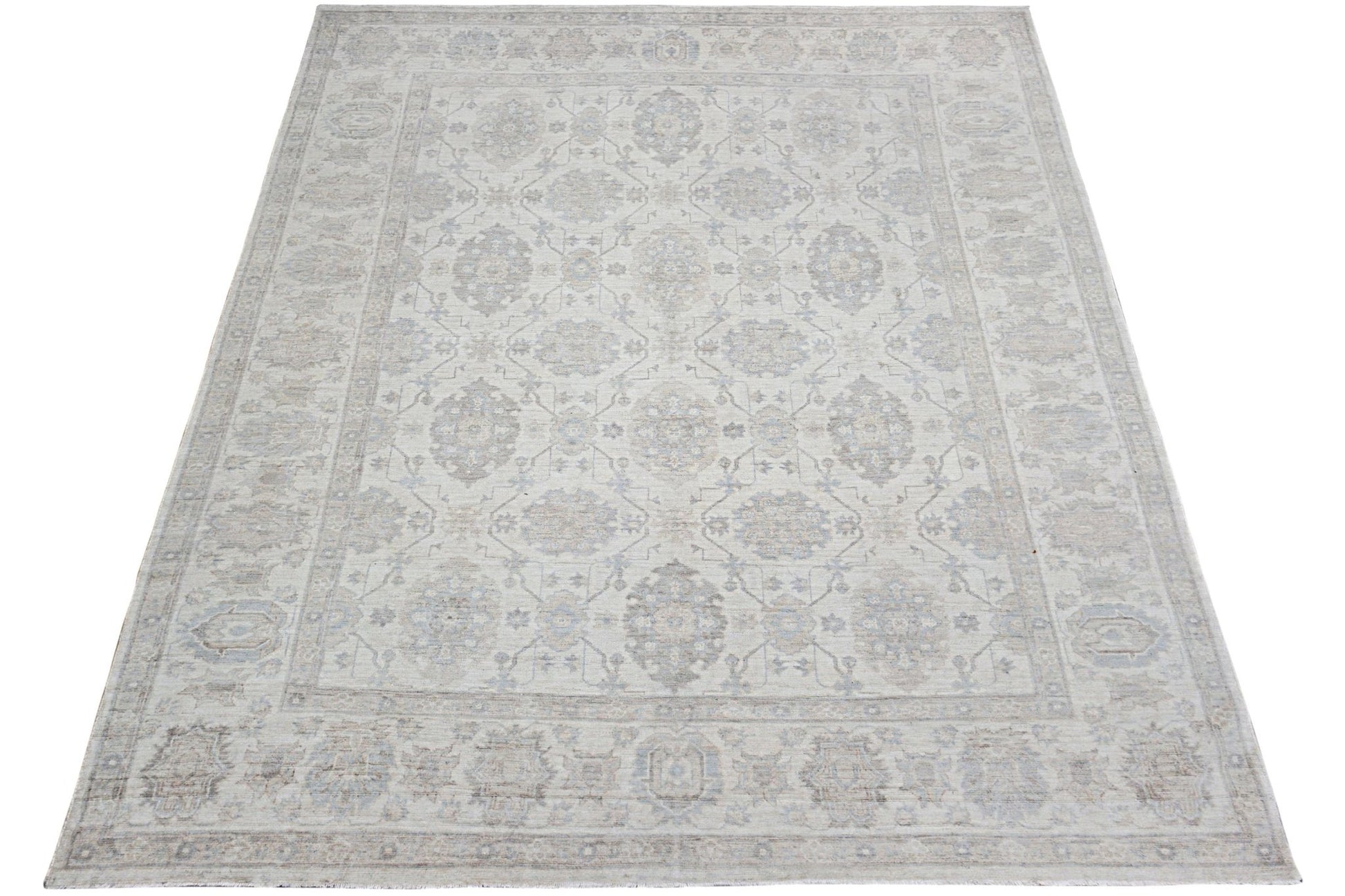 An Afghan Chobi rug featuring a traditional floral pattern in soft beige and grey tones.