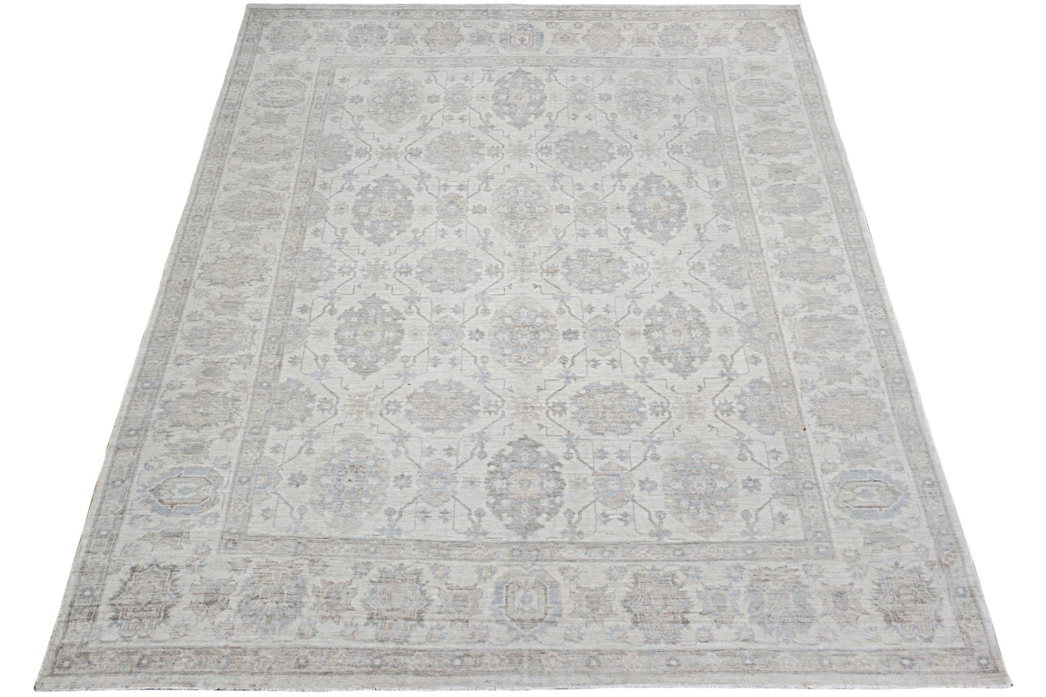 An Afghan Chobi rug featuring a traditional floral pattern in soft beige and grey tones.