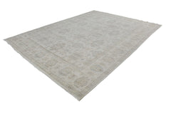 A handmade Afghan Chobi rug featuring a traditional floral pattern in neutral beige tones.
