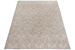 An Afghan Chobi rug featuring a traditional intricate floral pattern in soft beige and brown tones.