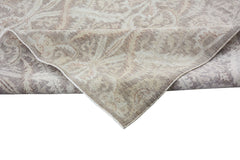 A handmade Afghan Chobi rug featuring a traditional floral pattern in neutral wood tones.
