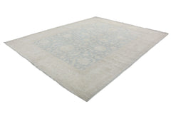 An Afghan Chobi rug featuring a traditional floral pattern in soft blue and beige tones.