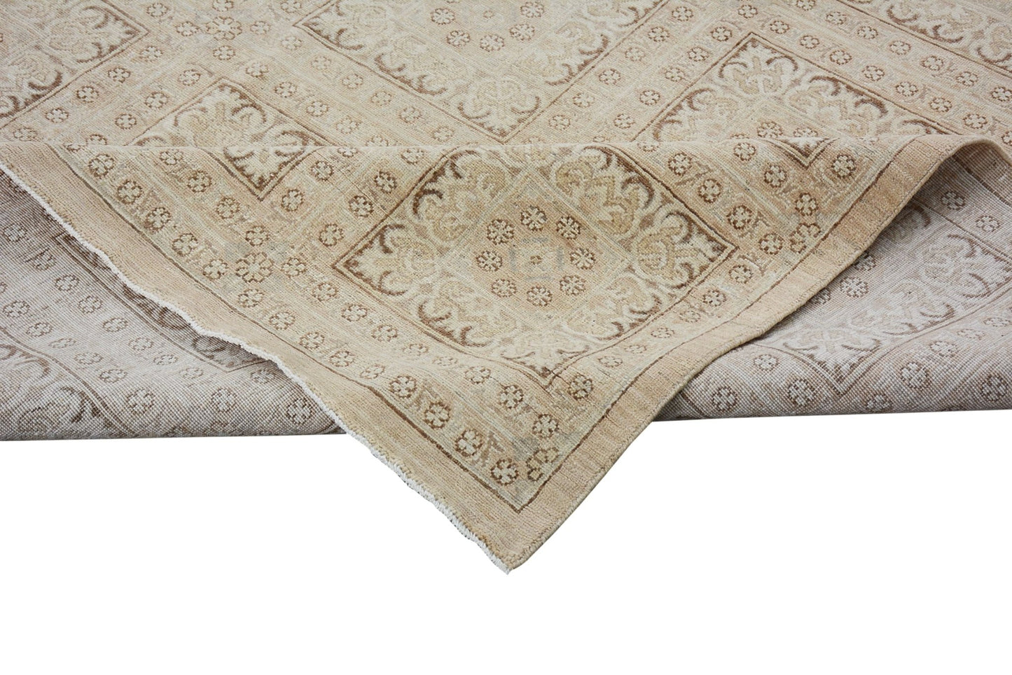 A handmade Afghan Chobi rug featuring a traditional geometric pattern in neutral wood tones.