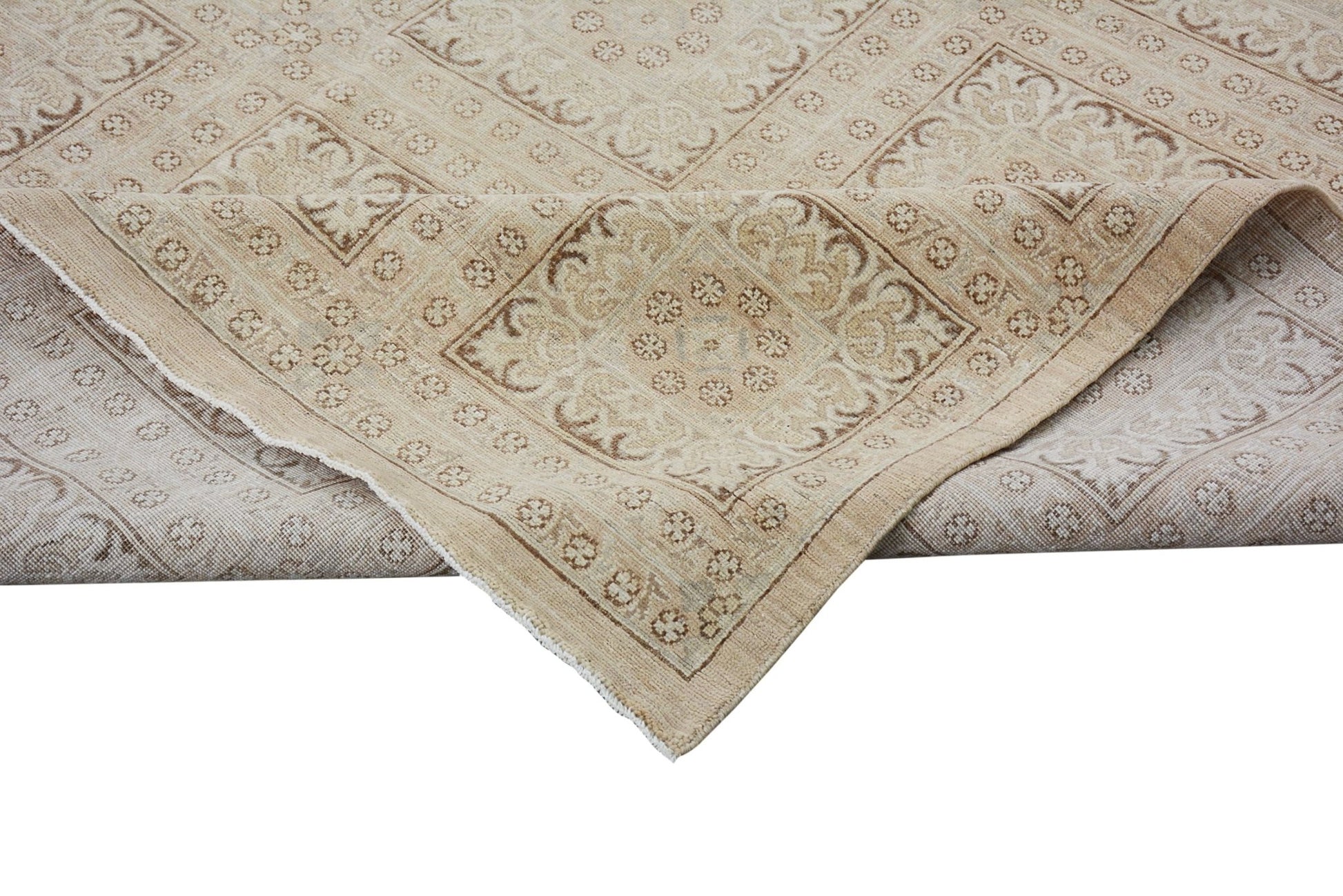 A handmade Afghan Chobi rug featuring a traditional geometric pattern in neutral wood tones.