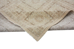A handmade Afghan Chobi rug featuring a traditional geometric pattern in neutral wood tones.