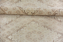A handmade Afghan Chobi rug featuring a traditional beige and brown floral pattern.