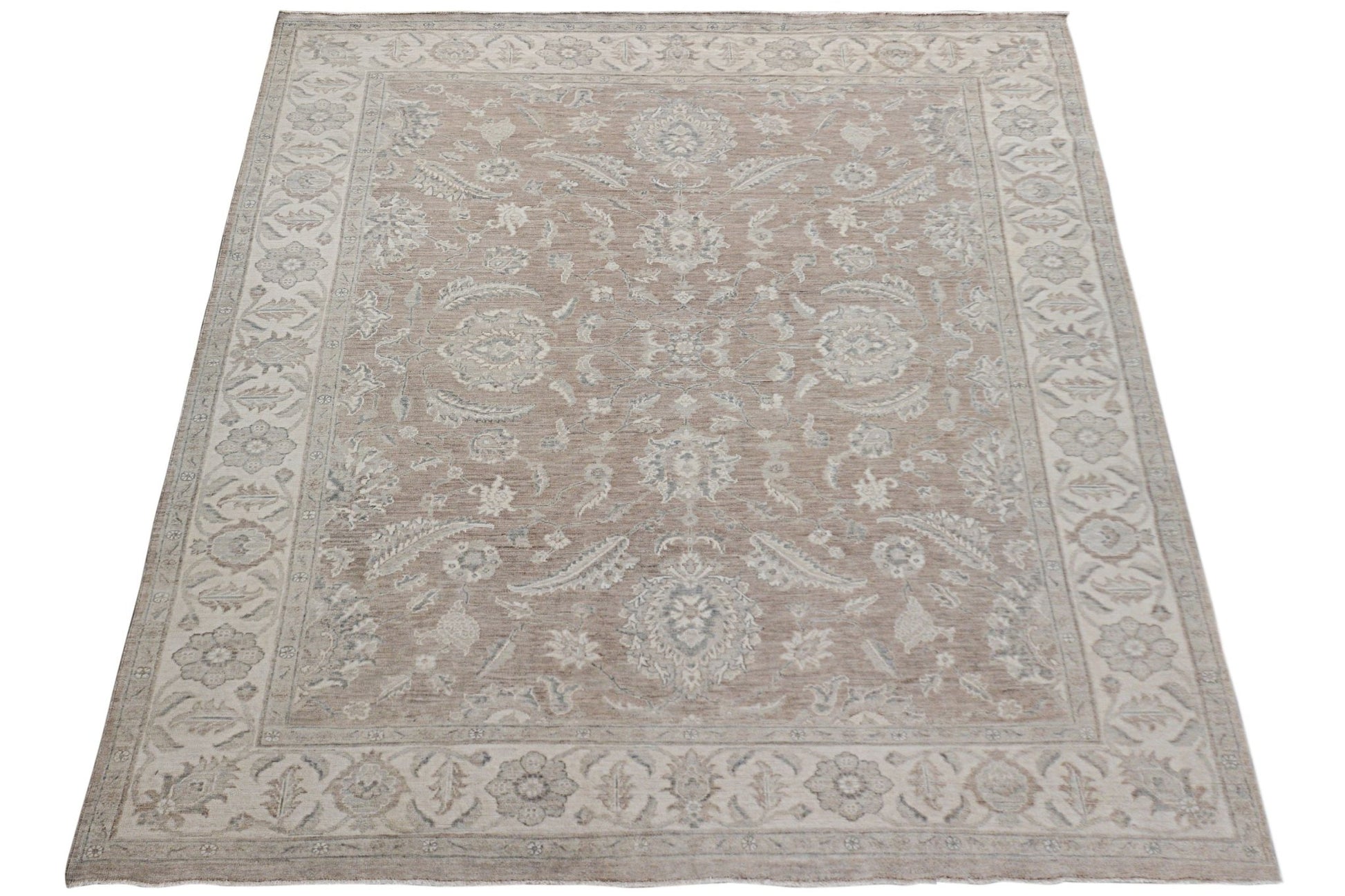 An Afghan Chobi rug featuring a traditional floral pattern in soft beige and grey tones.