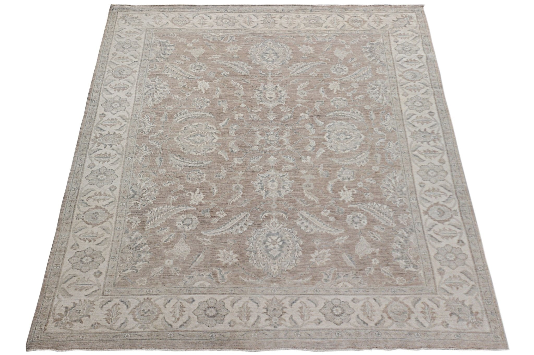 An Afghan Chobi rug featuring a traditional floral pattern in soft beige and grey tones.