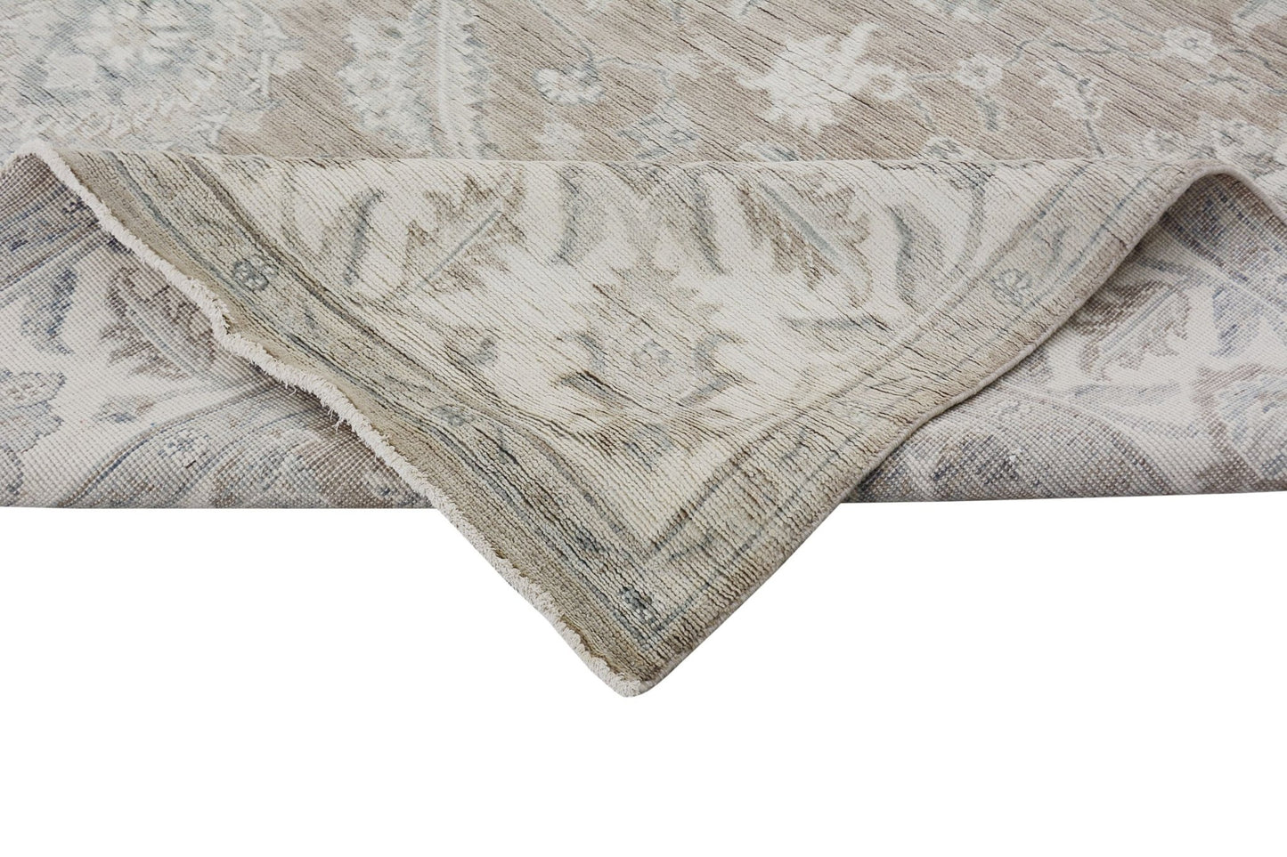 A handmade Afghan Chobi rug with a traditional floral pattern in neutral wood tones.