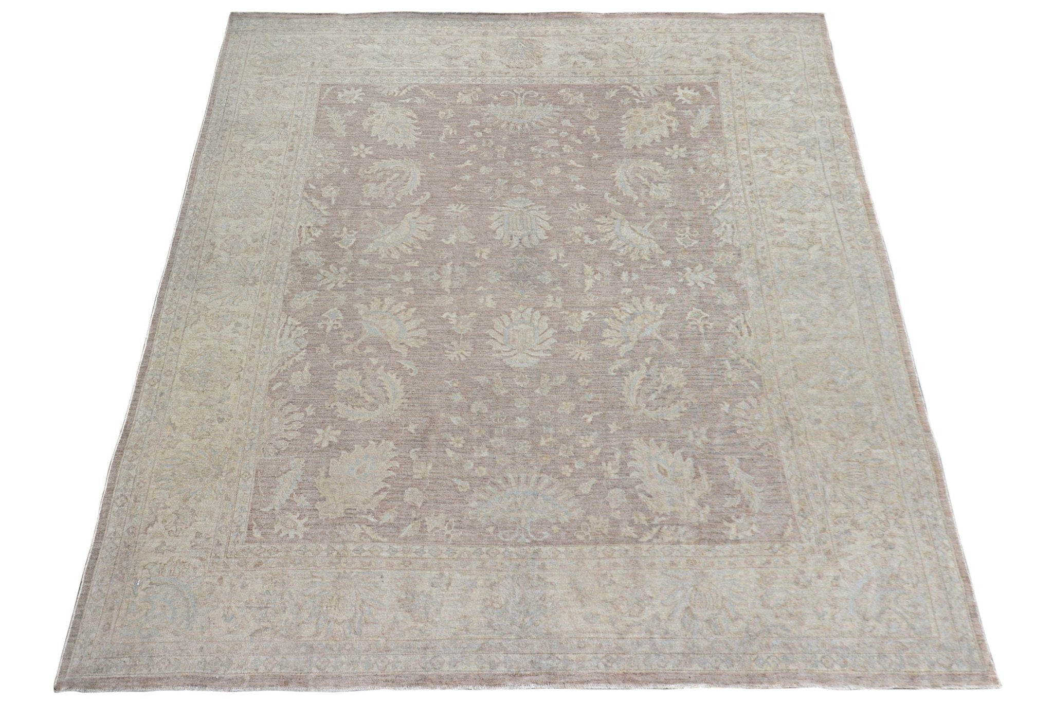 A rectangular Afghan Chobi rug featuring a muted mauve field with intricate floral patterns.