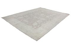 A handmade Afghan Chobi rug featuring a traditional floral pattern in neutral beige tones.