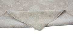 A handmade Afghan Chobi rug in neutral beige tones with a traditional floral pattern.