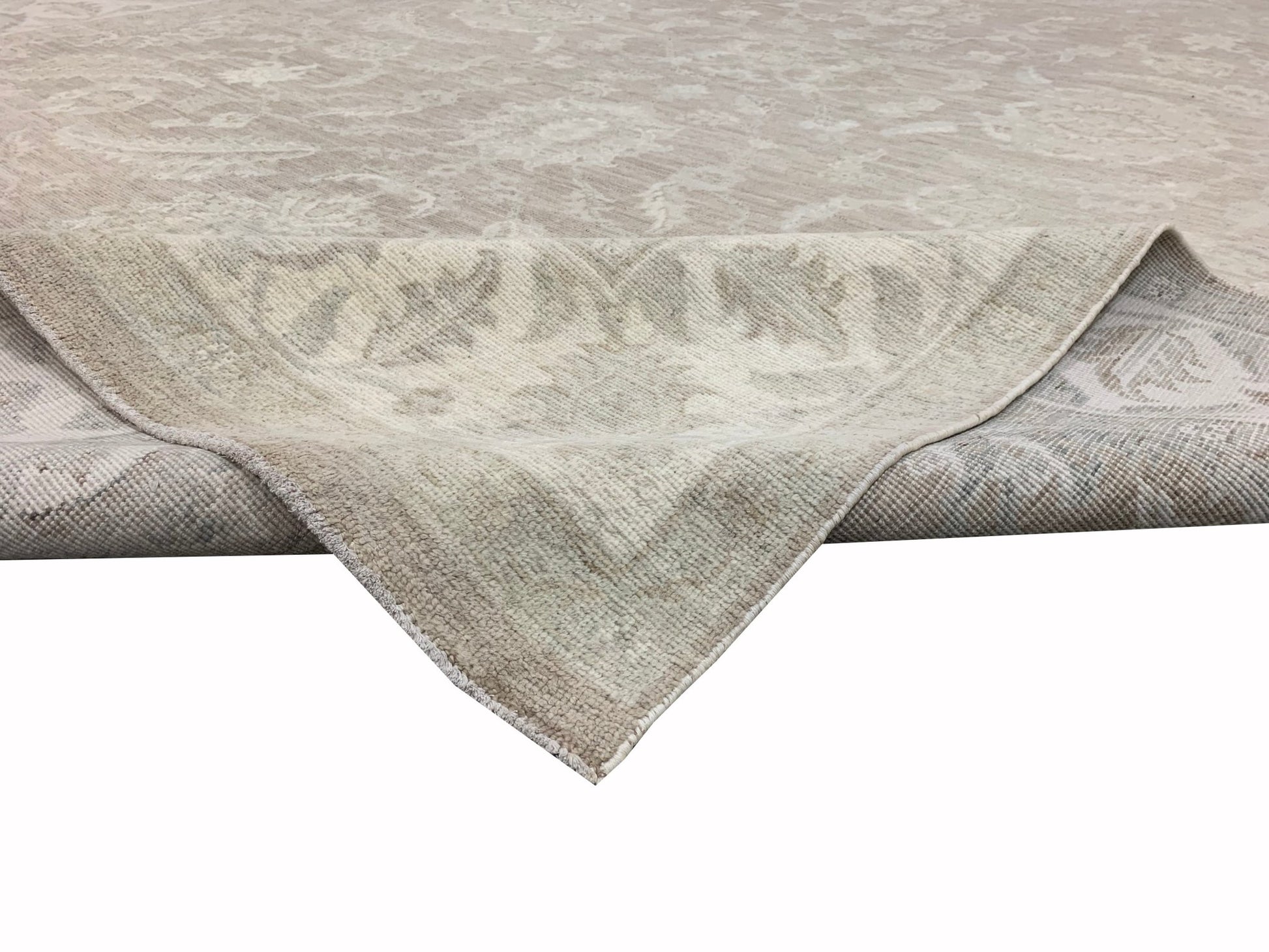 A handmade Afghan Chobi rug featuring a traditional floral pattern in neutral beige tones.