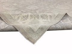 A handmade Afghan Chobi rug featuring a traditional floral pattern in neutral beige tones.