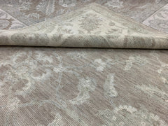A handmade Afghan Chobi rug featuring a traditional floral pattern in neutral beige tones.