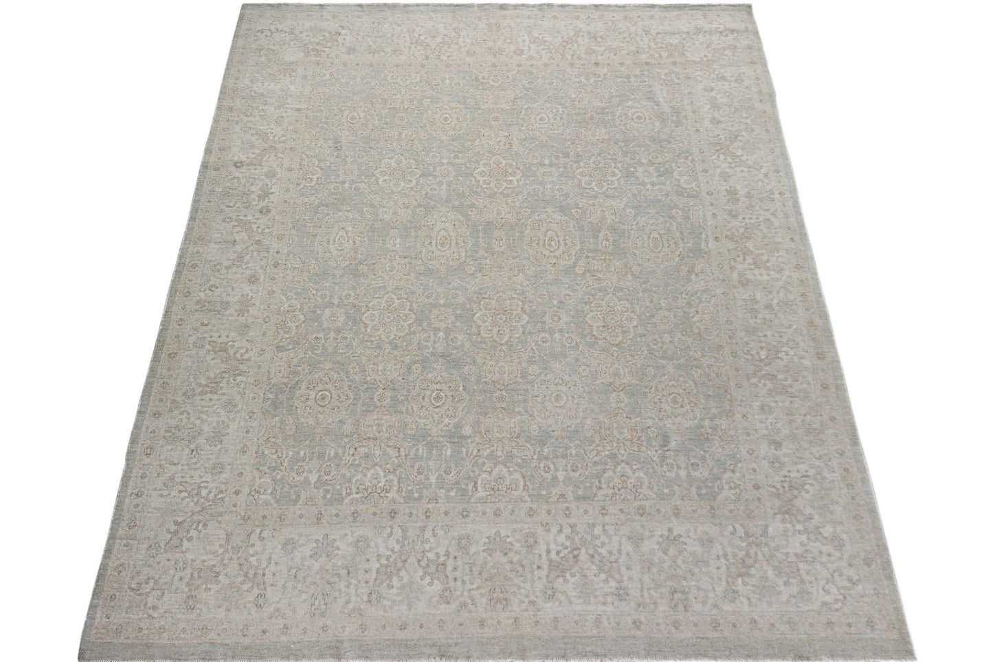 A handmade Afghan Chobi rug featuring a traditional floral pattern in soft beige and grey tones.