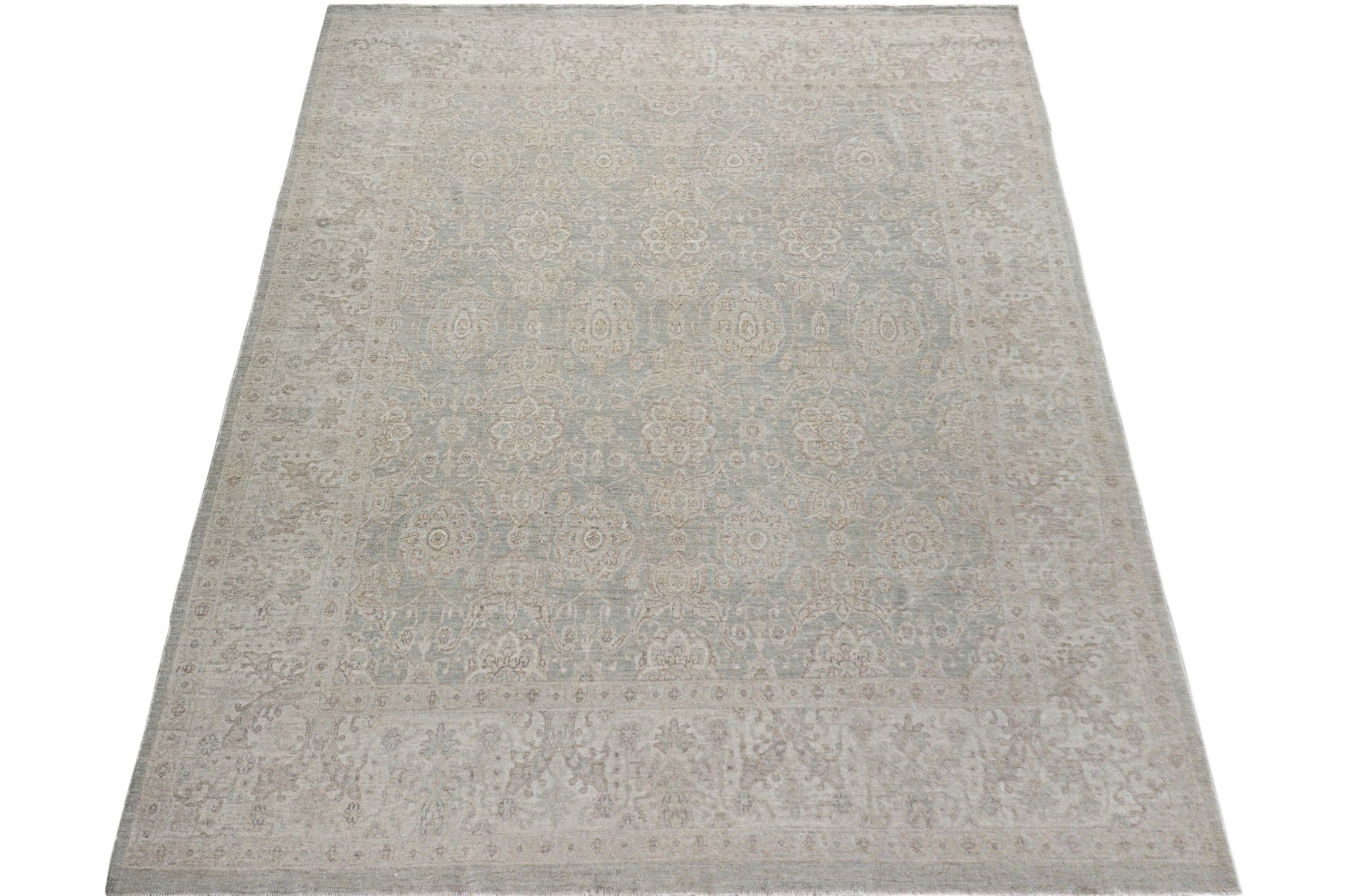 A handmade Afghan Chobi rug featuring a traditional floral pattern in soft beige and grey tones.
