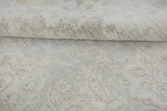 A handmade Afghan Chobi rug featuring a subtle, light-toned traditional pattern in wool.