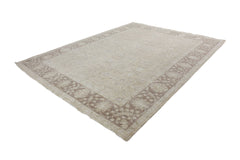 A handmade Afghan Chobi rug featuring a traditional floral pattern in neutral beige and brown tones.