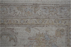 A close-up view of an Afghan Chobi rug featuring a neutral palette with subtle, earthy patterns.