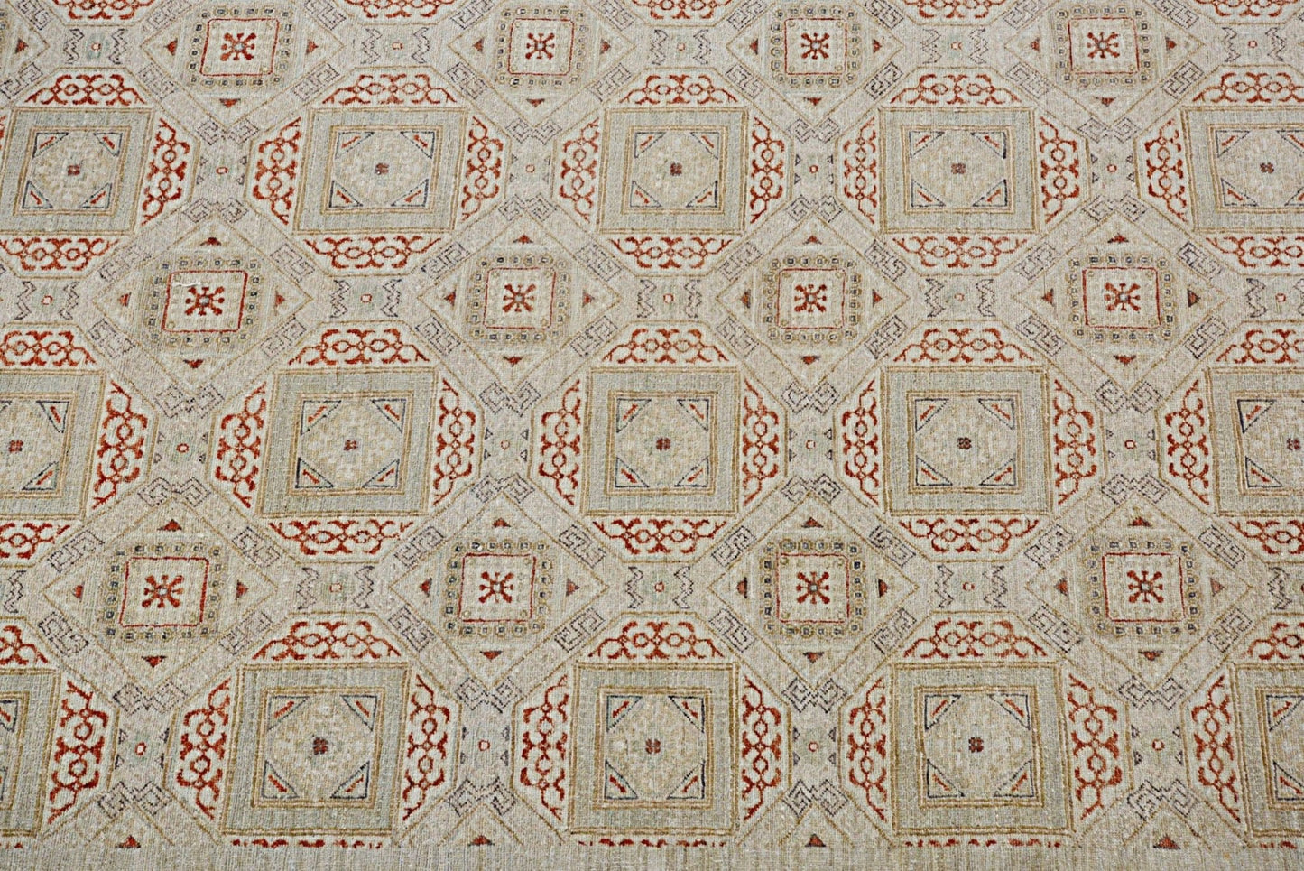 Handmade Afghan Chobi rug featuring a geometric pattern in earthy red and beige tones.