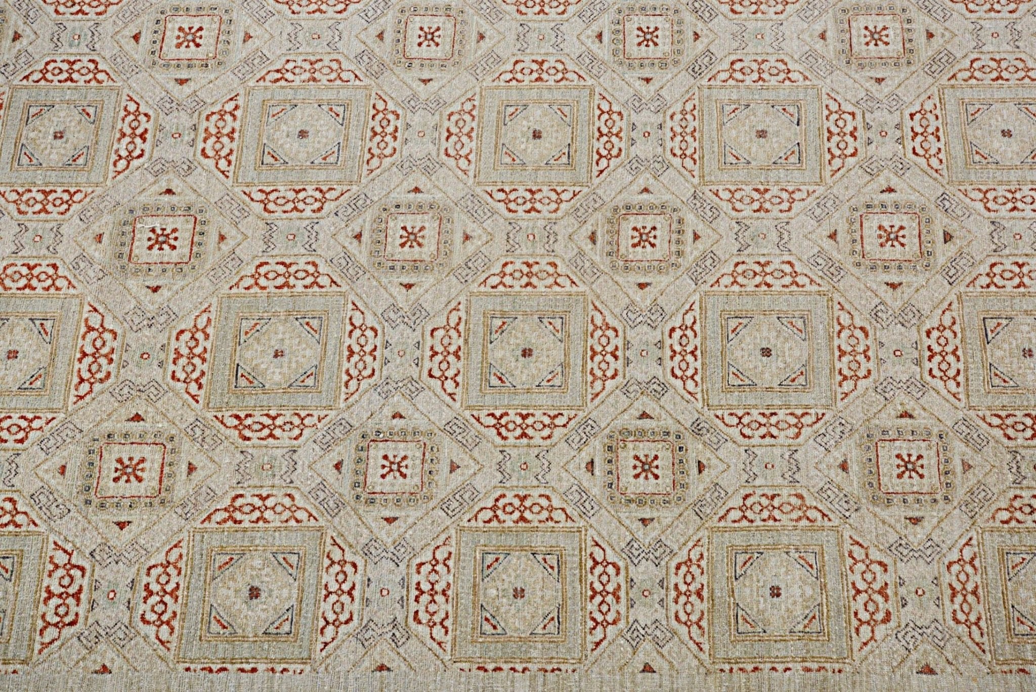 Handmade Afghan Chobi rug featuring a geometric pattern in earthy red and beige tones.