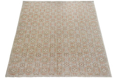 An Afghan Chobi rug featuring a repeating geometric pattern in earthy tones on a light background.