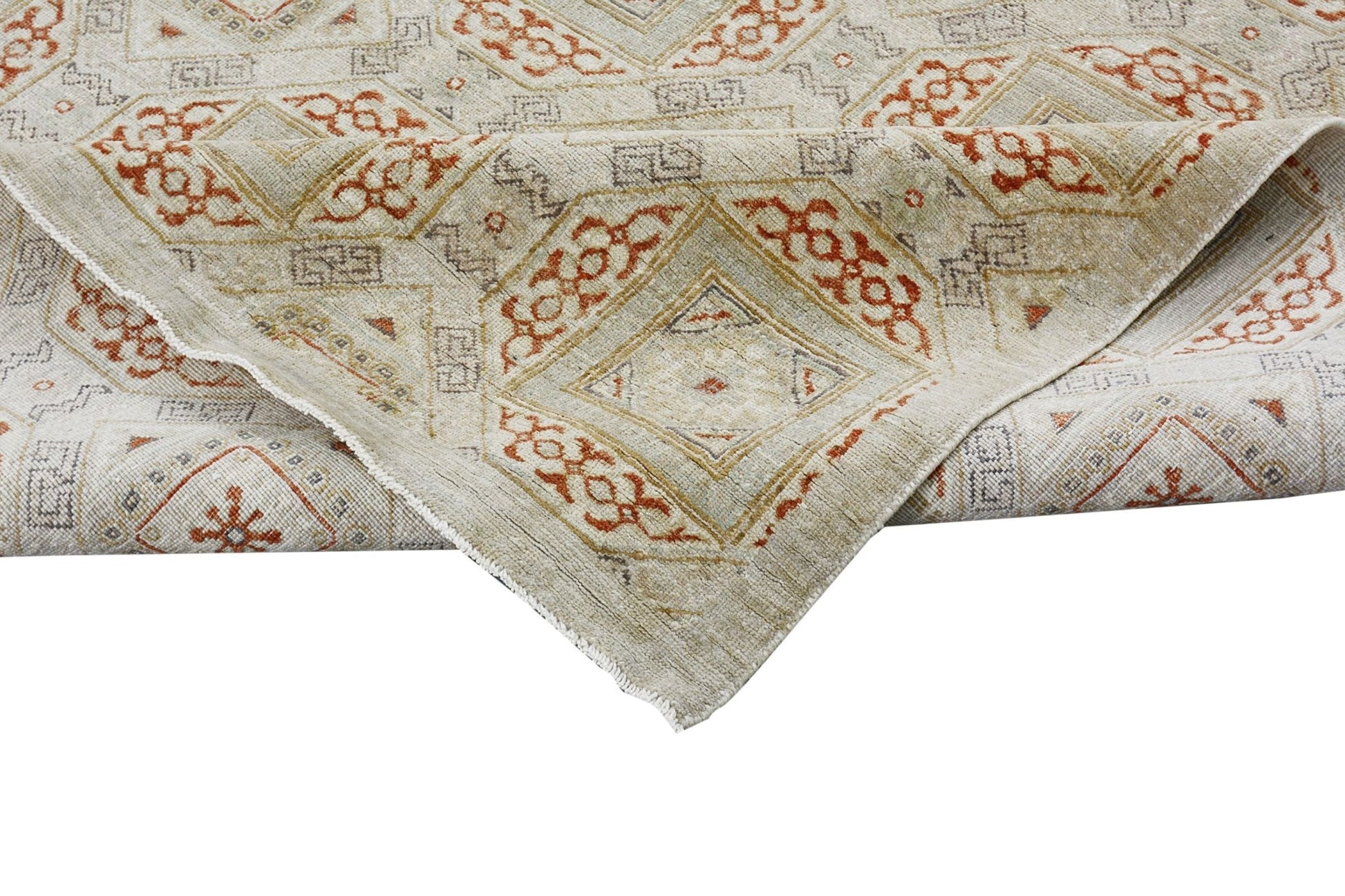 A handmade Afghan Chobi rug featuring a geometric diamond pattern in earthy tones.