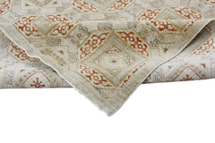 A handmade Afghan Chobi rug featuring a geometric diamond pattern in earthy tones.