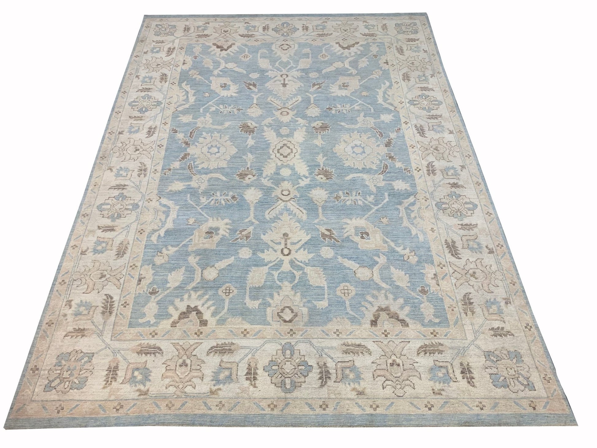 A rectangular Afghan Chobi rug featuring a traditional floral pattern in blue and beige tones.