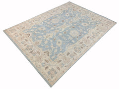 A handmade Afghan Chobi rug featuring a traditional floral pattern in shades of blue and beige.