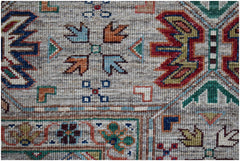 A handwoven Afghan Chobi rug featuring intricate geometric patterns in earthy, multi-colored tones.