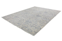 An Afghan Chobi rug featuring a traditional blue floral pattern on a light beige wool background.