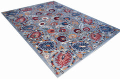 An Afghan Chobi rug featuring a traditional floral pattern in red and blue on a light blue field.