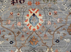 A handwoven Afghan Chobi rug featuring a traditional floral pattern in muted earth tones.