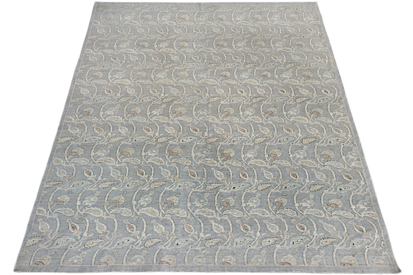 A handmade Afghan Chobi rug featuring a repeating floral vine pattern in soft grey and beige tones.