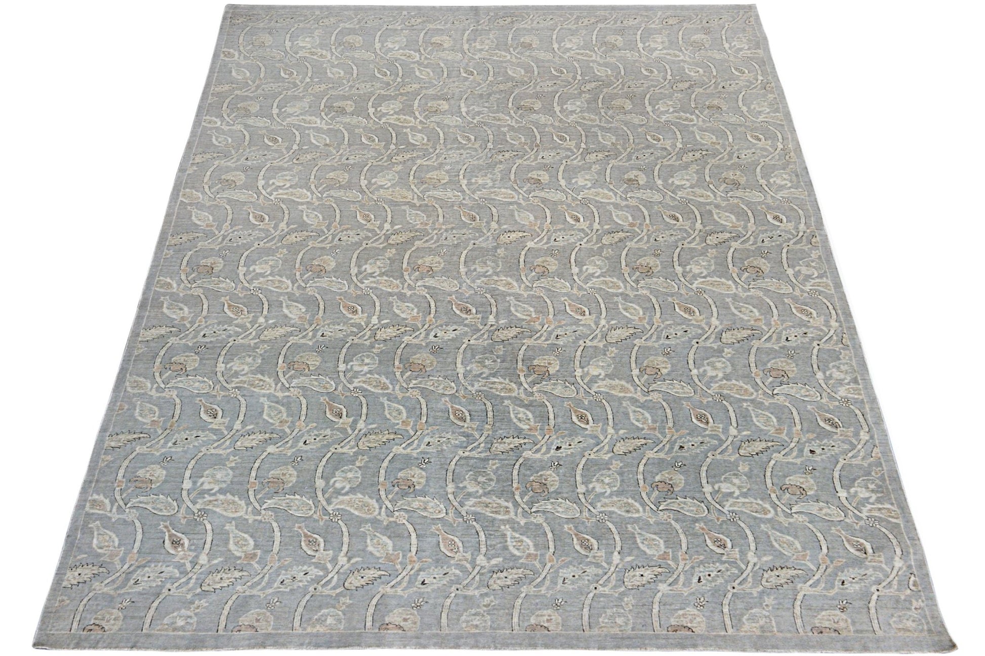 A handmade Afghan Chobi rug featuring a repeating floral vine pattern in soft grey and beige tones.