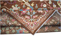 A handwoven Afghan Chobi rug featuring a traditional floral pattern in earthy brown tones.