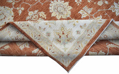 A handwoven Afghan Chobi rug featuring a floral pattern in rust and cream tones.