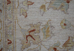 A close-up of a handwoven Afghan Chobi rug featuring traditional floral patterns in earthy tones.
