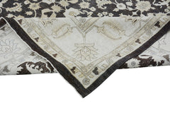 A handmade Afghan Chobi rug featuring a traditional floral pattern in dark brown and cream tones.